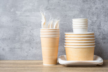 Eco friendly food packaging on table background. natural container: cup, plate, spoon and fork. zero waste, pollution, earth day, free plastic, world Environment day concept