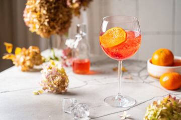 Italian Aperol Spritz cocktail with orange slices on gray stone table. Summer drink, homemade...