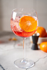 Italian Aperol Spritz cocktail with orange slices on gray stone table. Summer drink, homemade sangria. Copy space