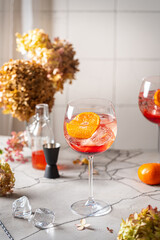 Italian Aperol Spritz cocktail with orange slices on gray stone table. Summer drink, homemade sangria. Copy space