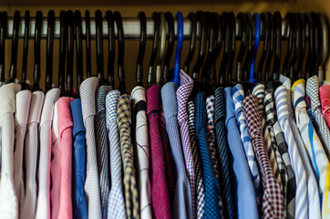 Men's shirts on hangers in the wardrobe