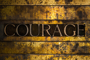 Courage text on textured grunge copper and vintage gold background