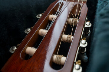 Guitar Arm on black background from hard case. Classic acoustic guitar concept