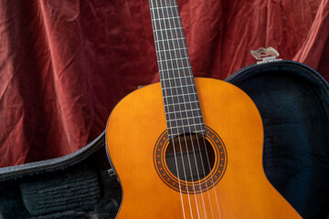 Fototapeta premium Acoustic Guitar on red background. Classic guitar concept.