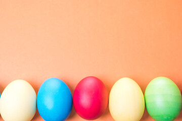 Fototapeta na wymiar multicolored Easter eggs on a brown background, close-up, space for text, blank for design, selective focus, tinted image.