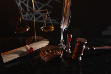 Last will with wax seal, rings and judge gavel on a glossy table. Divorce or legacy concept