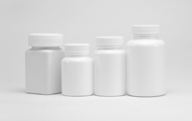 White plastic pill jars on a white background. Isolated