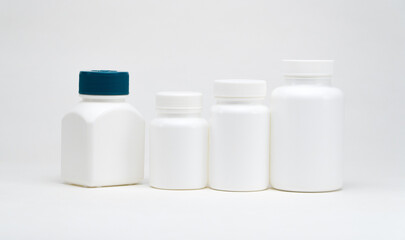 White plastic pill jars on a white background. Isolated