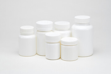 White plastic pill jars on a white background. Isolated