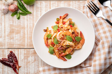 Spicy salad with shrimp.Thai style prawn salad with lemongrass shallot mint mixed with Chili Paste and lime sauce (pla goong).Top view