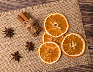 Dry orange oranges. Dried citrus fruits. Tropical fruit. On a brown background.