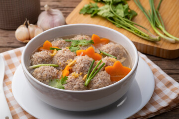 Close up Clear glass noodle soup with Minced Pork and carrot.Asian Meatball Soup with cellophane noodle (Gaeng Jued Woon Sen)