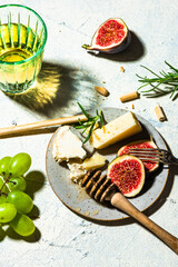 Cheese Appetizer with Figs and Grapes on Table
