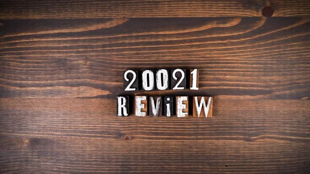 2021 review. Alphabet letters on a wooden background