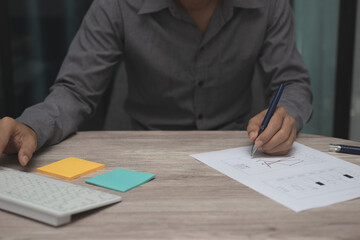 business man working on table at office. man hand use pen pointing on business graph or chart with keyboard, smartphone and tablet to analysis statistics and strategy for investment success target.