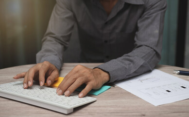 business man working on table at office. man hand typing on keyboard with business graph or chart to analysis statistics and strategy for investment success target.