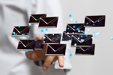 Hand holding using mobile phone with email icon on screen. Concept of business communication