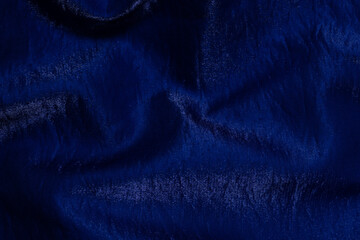 Purple shiny fabric as background. Top view.