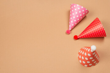 Colorful birthday cap on brown  background.