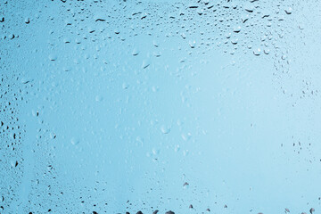 Blue backgrond with water drops. Wet glass.