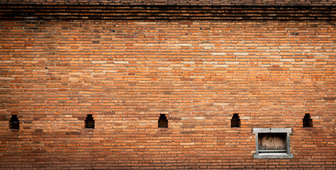 Aged red brick wall with windows background, Chiang Mai old city wall gate, Thailand