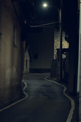 Narrow mountain road passing between the houses