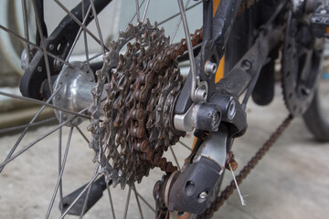 Close up of dirty bicycle rear gear and rusty chain, maintenance concept