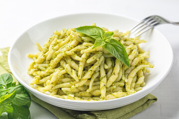 Trofie al pesto, italian pasta with pesto sauce. Close-up.