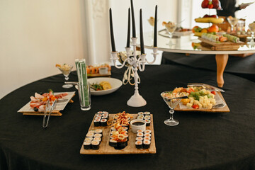 Sushi Set nigiri and sushi rolls with candles served on the table in the restaurant
