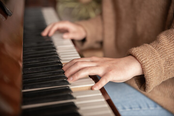 Fototapeta na wymiar Close-up of female hands playing the piano.