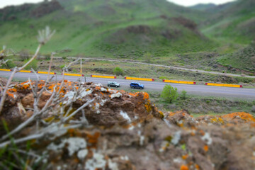 Look at car's miniature from rock during the travel