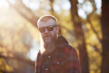 Blond bearded man in sunglasses in autumn evening