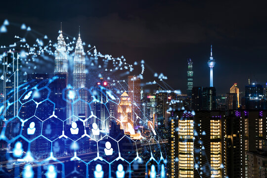 Glowing social media icons on night panoramic city view of Kuala Lumpur, Malaysia, Asia. The concept of networking and establishing new connections between people in businesses in KL. Double exposure. © VideoFlow