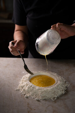 Chef pouring over flour 