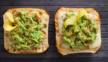 toasted slices of square bread with warm cheese and homemade guacamole on plate for healthy breakfast