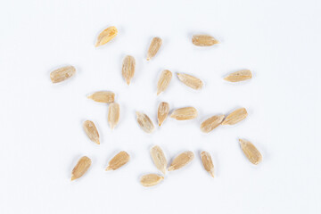 Peeled sunflower seeds on white background.