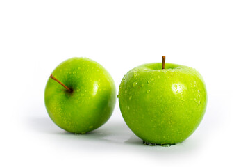 Juicy green apple with water drops on an isolated background.