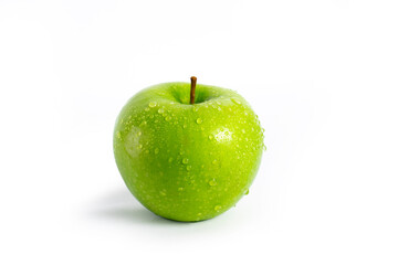 Juicy green apple with water drops on an isolated background.
