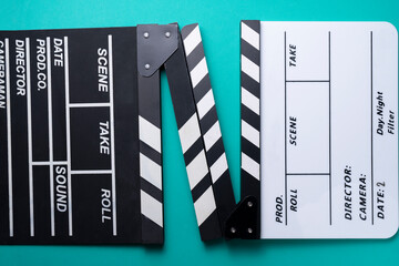 movie clapper on green table background ; film, cinema and video photography concept