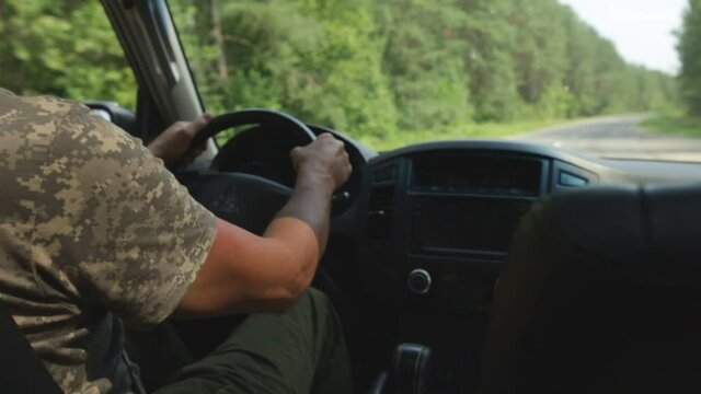 Man Riding Car Jeep On Bad Bumpy Road In Countryside Among Forest Trees In Summer.