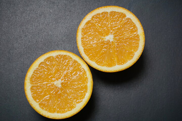 fresh oranges on black background