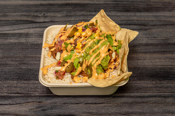 Mexican Burrito Bowl with Cooked White Rice, Guacamole, Cheddar Cheese Dip, Corn Chips, Jalapeños, Shredded Beef Stew, and Sweet Corn