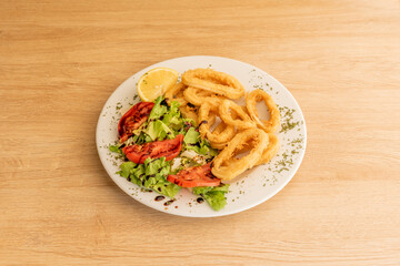 Serving of squid a la romana battered in flour and egg fried in olive oil served as Spanish tapas