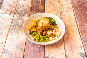 traditional nikkei ceviche recipe with white fish, coriander and lime juice, fat corn, sweet potato, nori seaweed and edamame beans