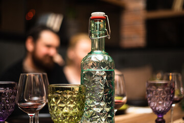 A glass for wine of an unusual shape on a festive table. High quality photo