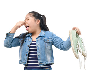 Young Asian girl feeling unhappy with bad smell sneaker shoes isolated - obrazy, fototapety, plakaty