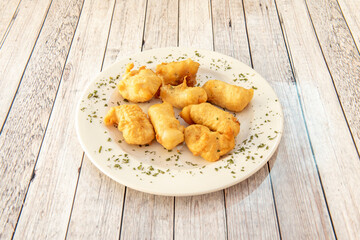 Crispy cod with chopped parsley fried in olive oil served in a tapas restaurant