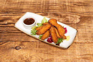 crispy chicken strips coated in wheat flour, panko and egg fried in olive oil with barbecue sauce