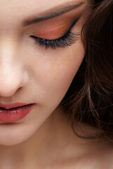 Closeup portrait of female face with red lips and smoky eyes beauty makeup.