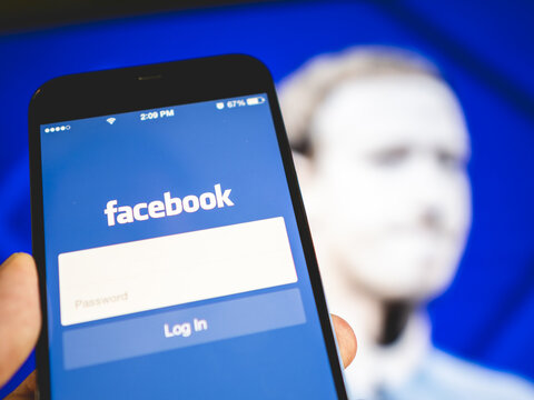 Faceook - login page - background with blurred image of a man
